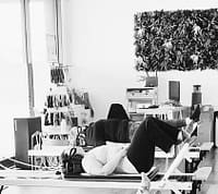 women doing footwork exercise in a reformer pilates class