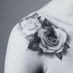 Roase tattoo on woman's shoulder