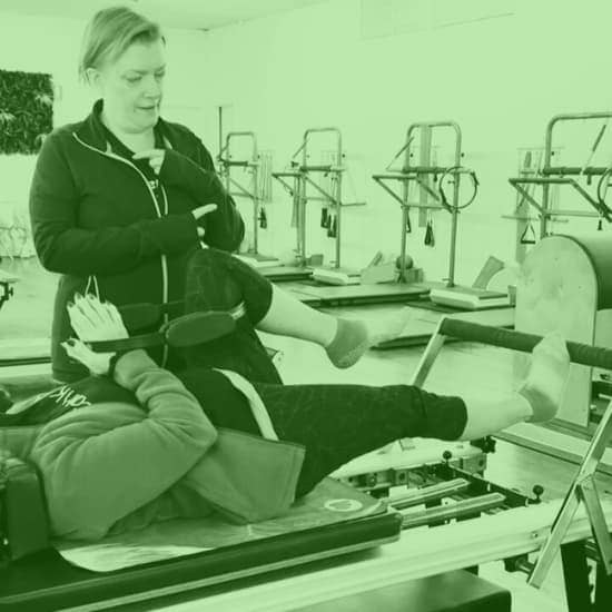 SOLO - Private Pilates 5 woman instructing a private reformer pilates session