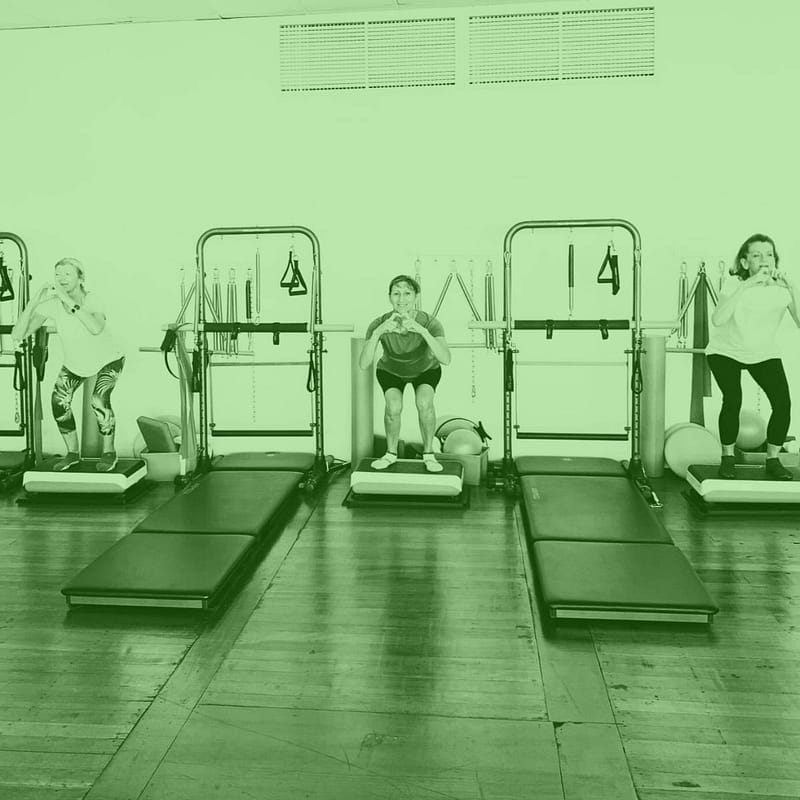 women doing a tower vibe pilates class